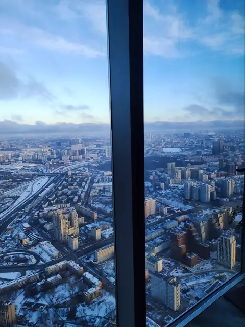 moscow seen through panoramic glass from a great height, the snow-covered city stretching to the horizon