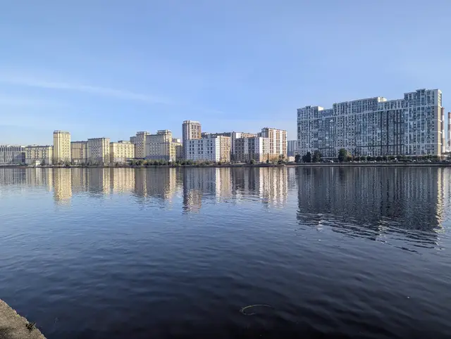 new apartment blocks along the neva, mirrored almost perfectly in still water